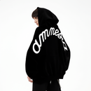 Person wearing a black hoodie with 'Amnesia' branding on the back against a white background