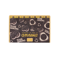 IQOS Wrap with a textured glitter finish, featuring '50 YEARS DANCING' and 'amnesia' printed in white and gold text, with a gold border.