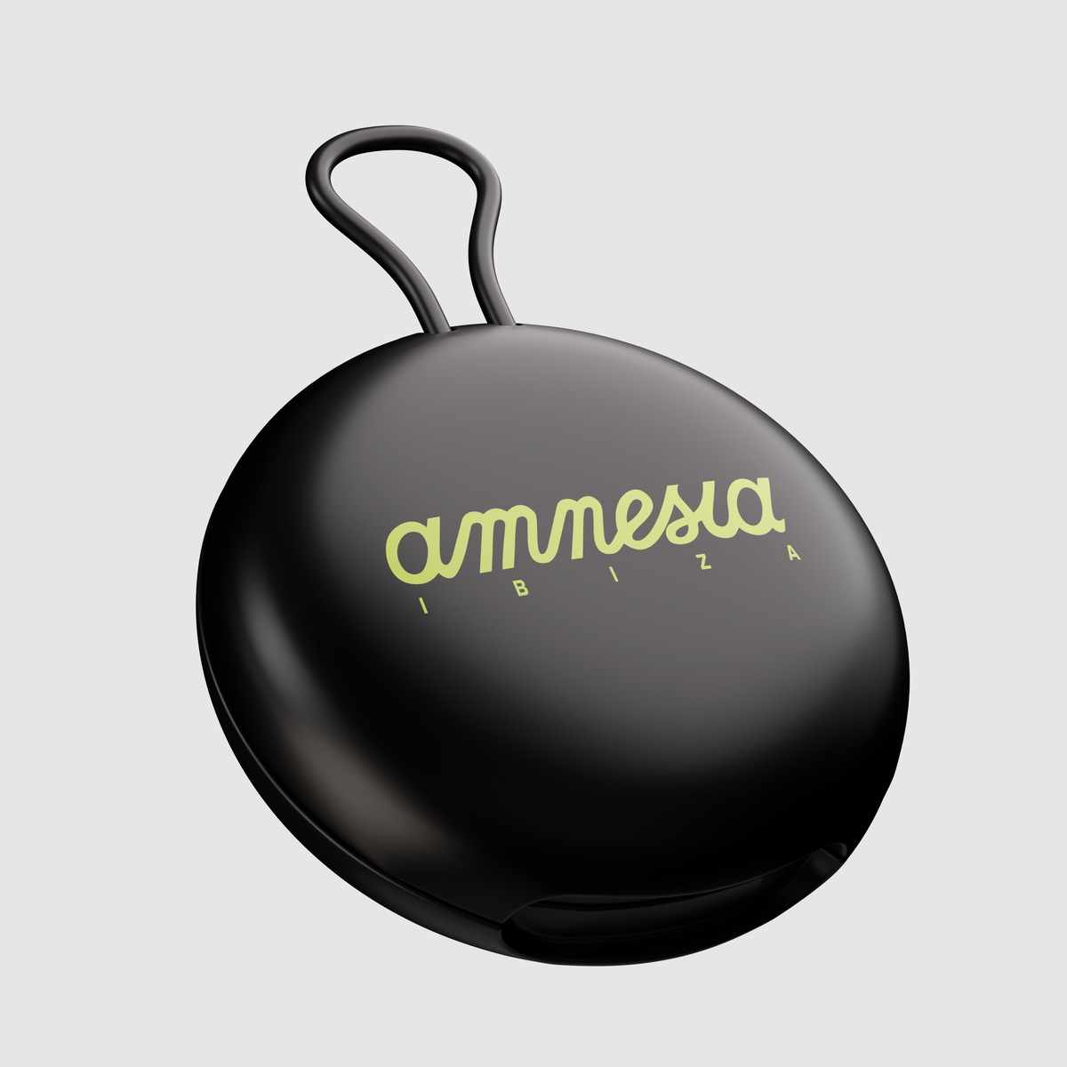 A black, circular, hard-shell case with a loop handle on top, featuring the brand name 'amnesia ibiza' printed in a light yellow-green script on the front, set against a solid light gray background.